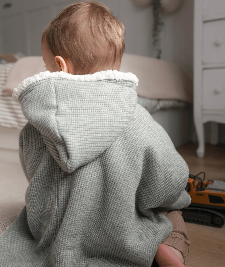 Evolving knitted poncho